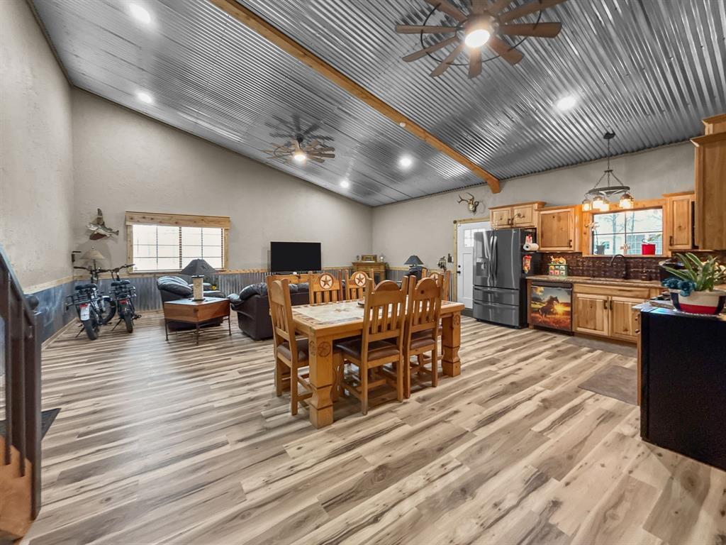 1477 Cedar Mills Road Gordonville, TX 76245 - Photo 5 of 21 Living room with a textured wall, light wood-style floors, and a ceiling fan