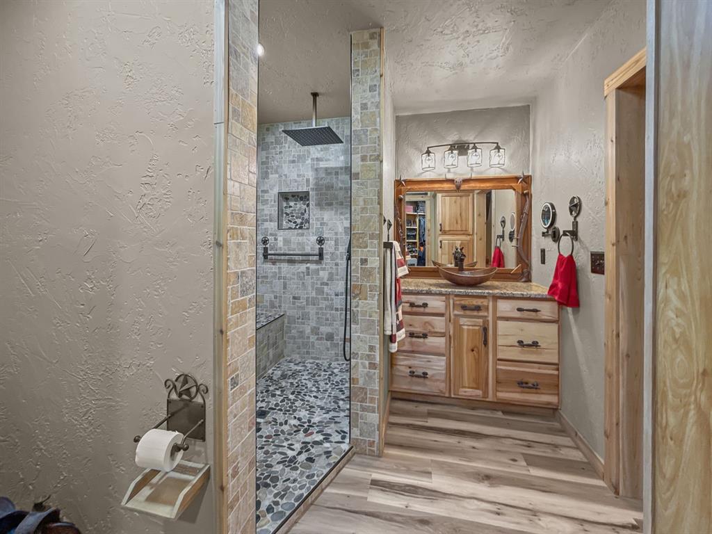 1477 Cedar Mills Road Gordonville, TX 76245 - Photo 7 of 21 Bathroom with visible vents, toilet, a spacious closet, and wood finished floors