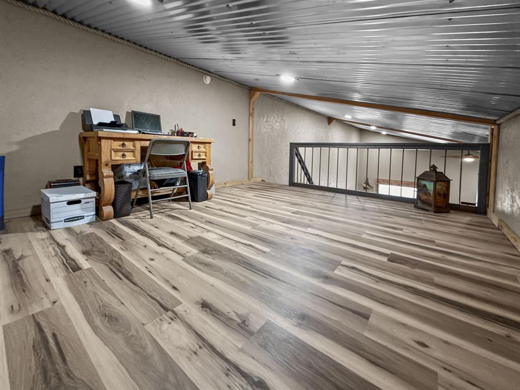 1477 Cedar Mills Road Gordonville, TX 76245 - Photo 9 of 21 loft area for office or guests featuring light wood-style flooring and ceiling fan