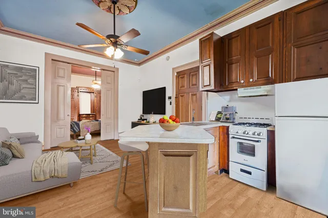 a kitchen with stainless steel appliances granite countertop a stove refrigerator and cabinets