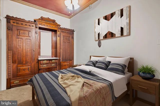 a bedroom with a bed and a dresser