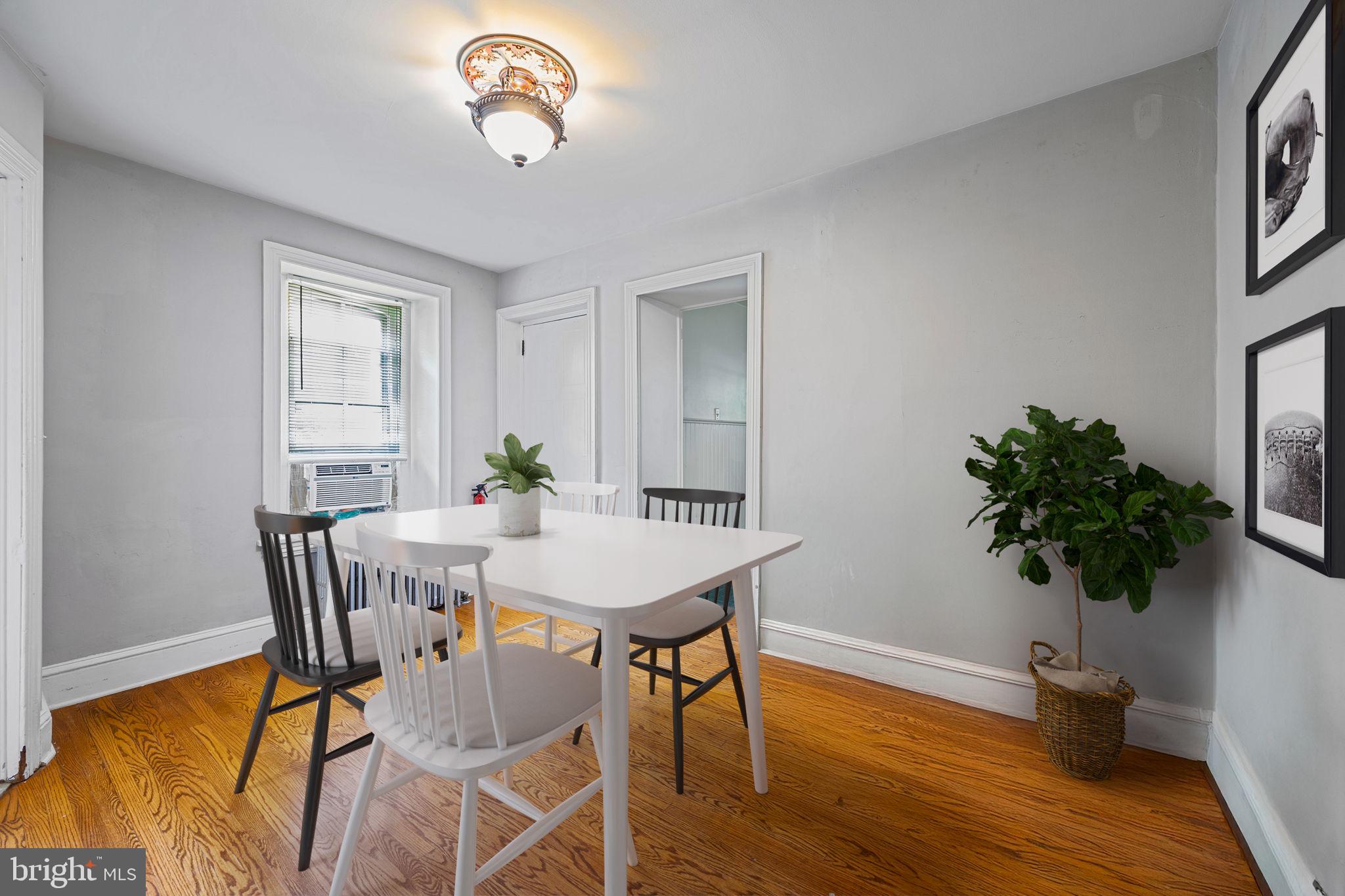 5911 Greene Street Philadelphia, PA 19144 - Photo 17 of 52 a view of a dining room with furniture and a potted plant