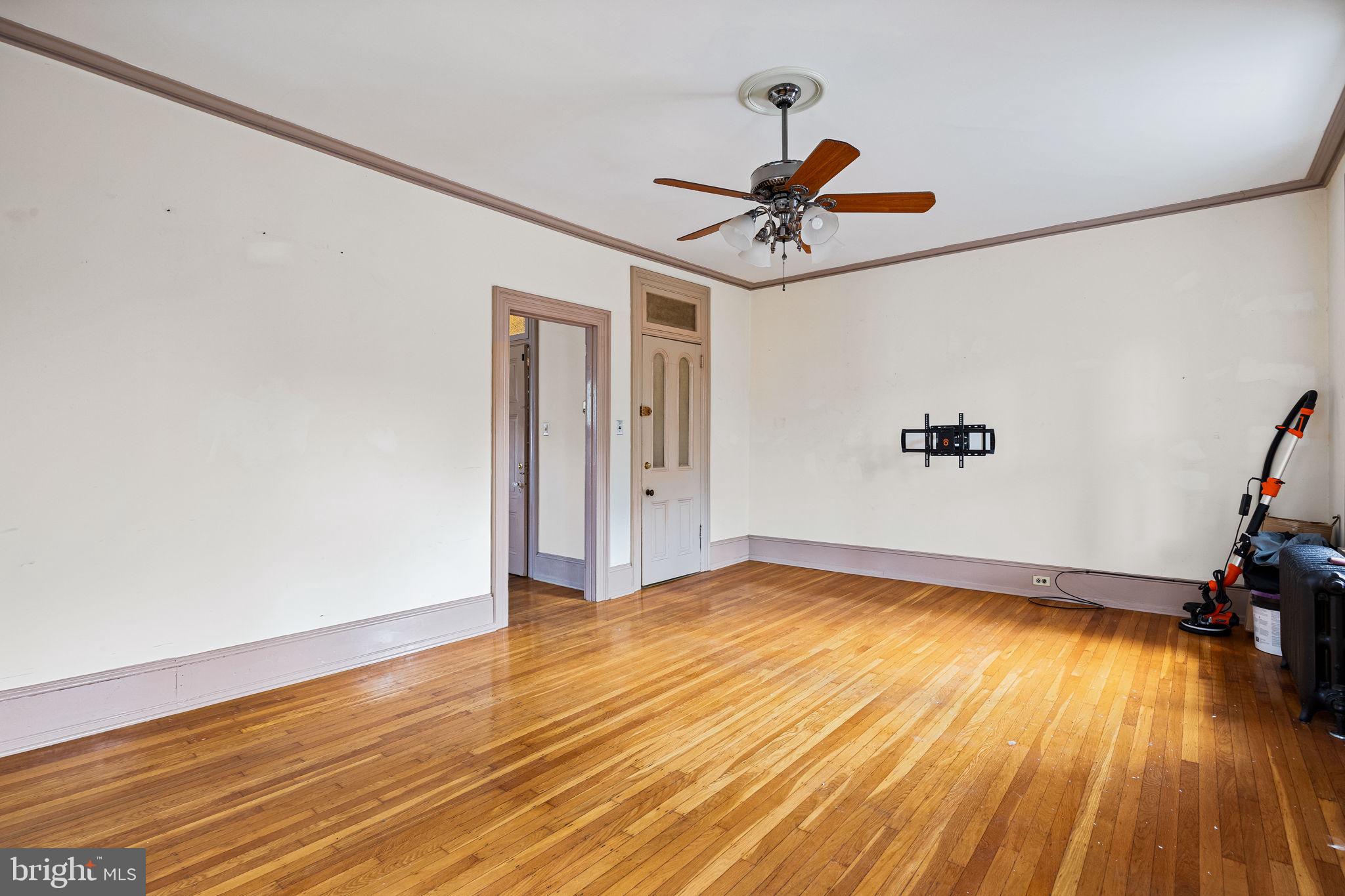 5911 Greene Street Philadelphia, PA 19144 - Photo 25 of 52 a view of a room with wooden floor and a ceiling fan