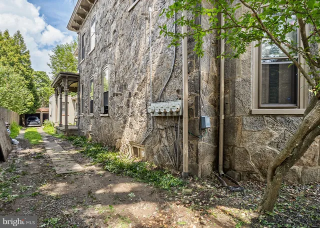 a pathway of a house with a yard