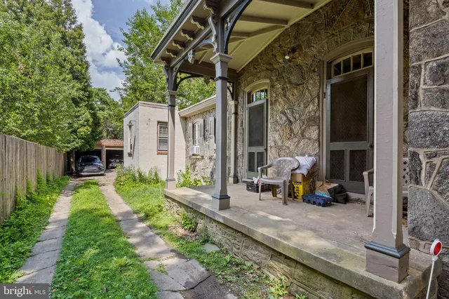 a view of a chair and tables in the patio of the house