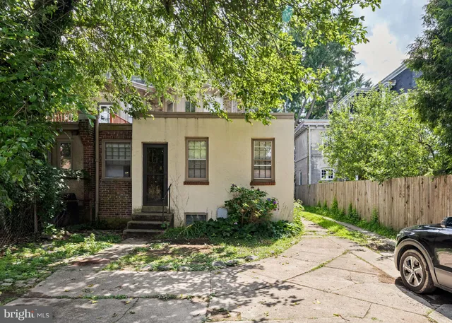 a front view of a house with a yard and a garage