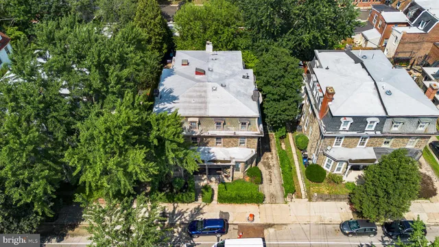 an aerial view of a house with a yard