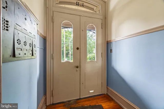 a view of front door with wooden floor