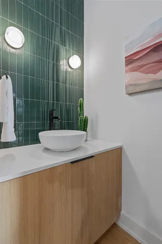 a bathroom with a granite countertop sink and a mirror