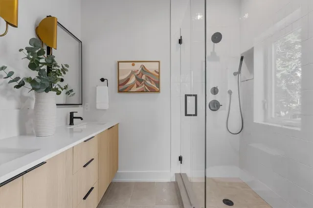 a bathroom with a tub sink and mirror