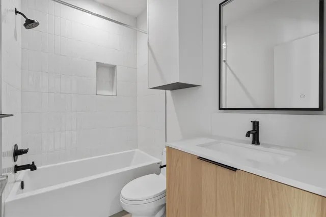 a bathroom with a sink a toilet and bathtub