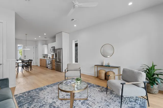 a living room with furniture kitchen view and a table