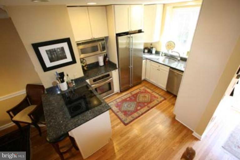 1123 Portner Road Alexandria, VA 22314 - Photo 2 of 10 a living room with furniture a flat screen tv and a refrigerator