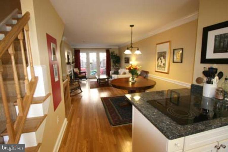 1123 Portner Road Alexandria, VA 22314 - Photo 3 of 10 a kitchen with granite countertop a sink dishwasher a stove and a dining table with wooden floor