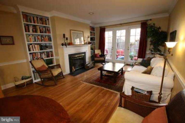 1123 Portner Road Alexandria, VA 22314 - Photo 4 of 10 a living room with furniture hard wood floor and a fireplace