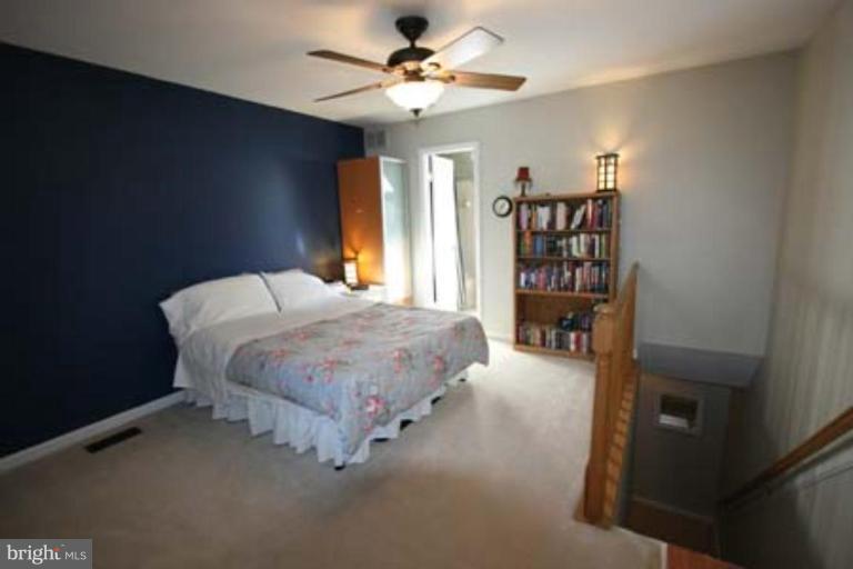 1123 Portner Road Alexandria, VA 22314 - Photo 7 of 10 a bedroom with a bed furniture and a chandelier