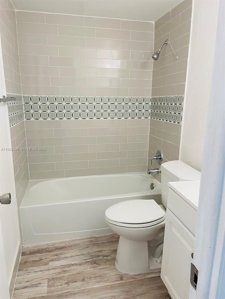 6701 Northwest 169th Street, Unit B301 Hialeah, FL 33015 - Photo 5 of 7 a bathroom with a toilet and a shower