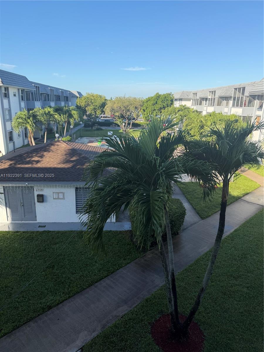 6701 Northwest 169th Street, Unit B301 Hialeah, FL 33015 - Photo 6 of 7 a view of a yard in front of a house