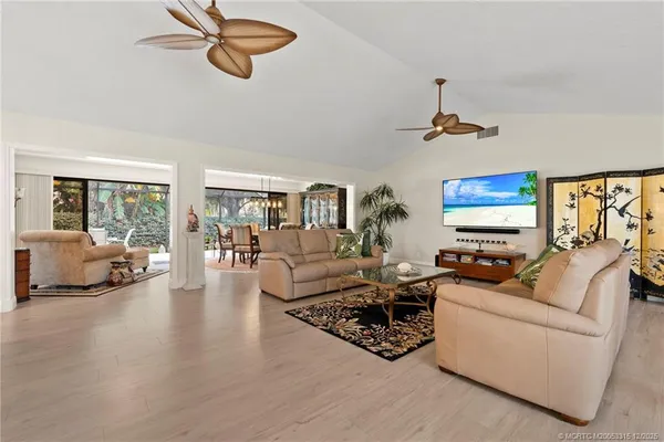 a living room with furniture window and a flat screen tv