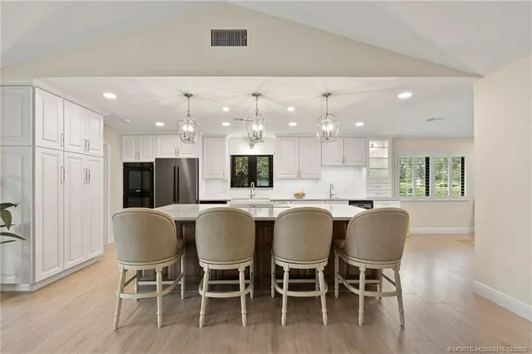 a large kitchen with dining table and chairs