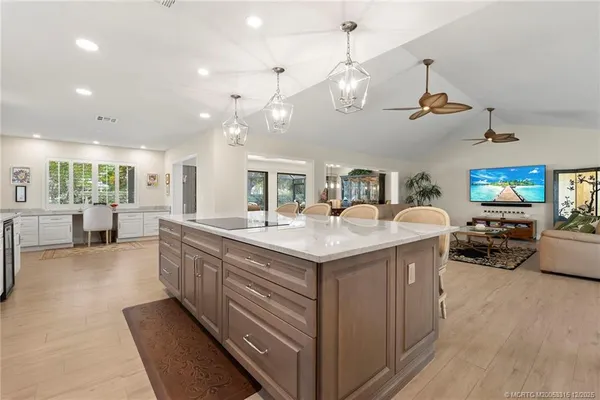 a large kitchen with stainless steel appliances granite countertop a lot of counter space