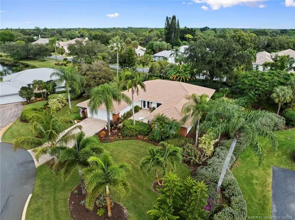an aerial view of a house with a yard and lake view