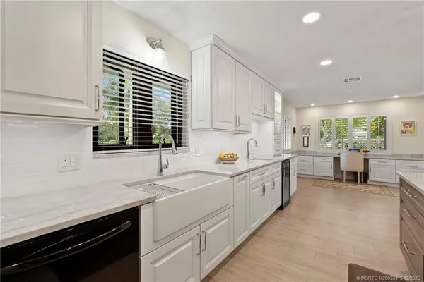 a kitchen with sink cabinets and window