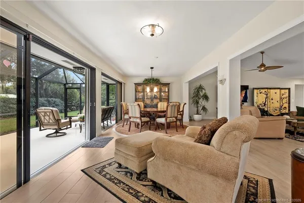 a living room with furniture fireplace and large windows