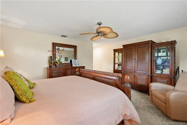 a bedroom with a bed mirror and window