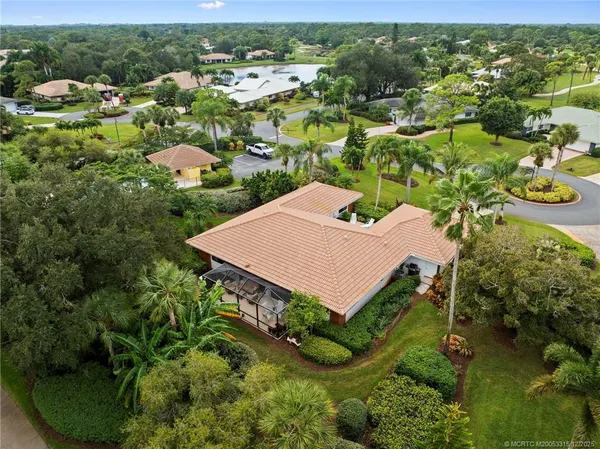 an aerial view of a house with a yard