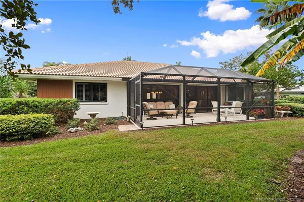 a view of a house with backyard porch and sitting area
