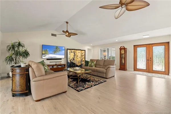 a living room with furniture and a chandelier