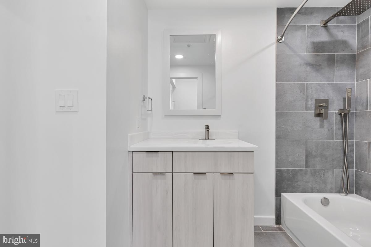 506 H Street Northeast, Unit 401 Washington, DC 20002 - Photo 14 of 19 a bathroom with a sink a bathtub and a shower