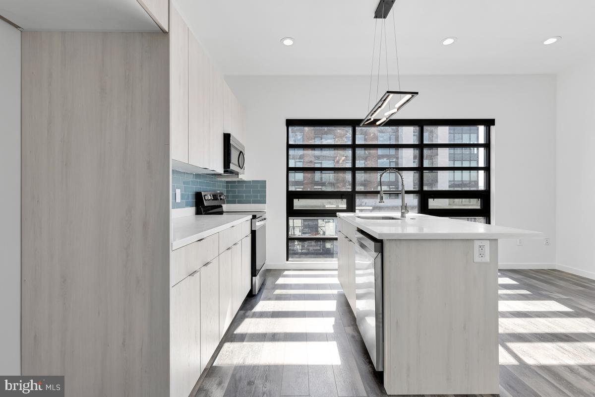 506 H Street Northeast, Unit 401 Washington, DC 20002 - Photo 5 of 19 a kitchen with a sink and cabinets