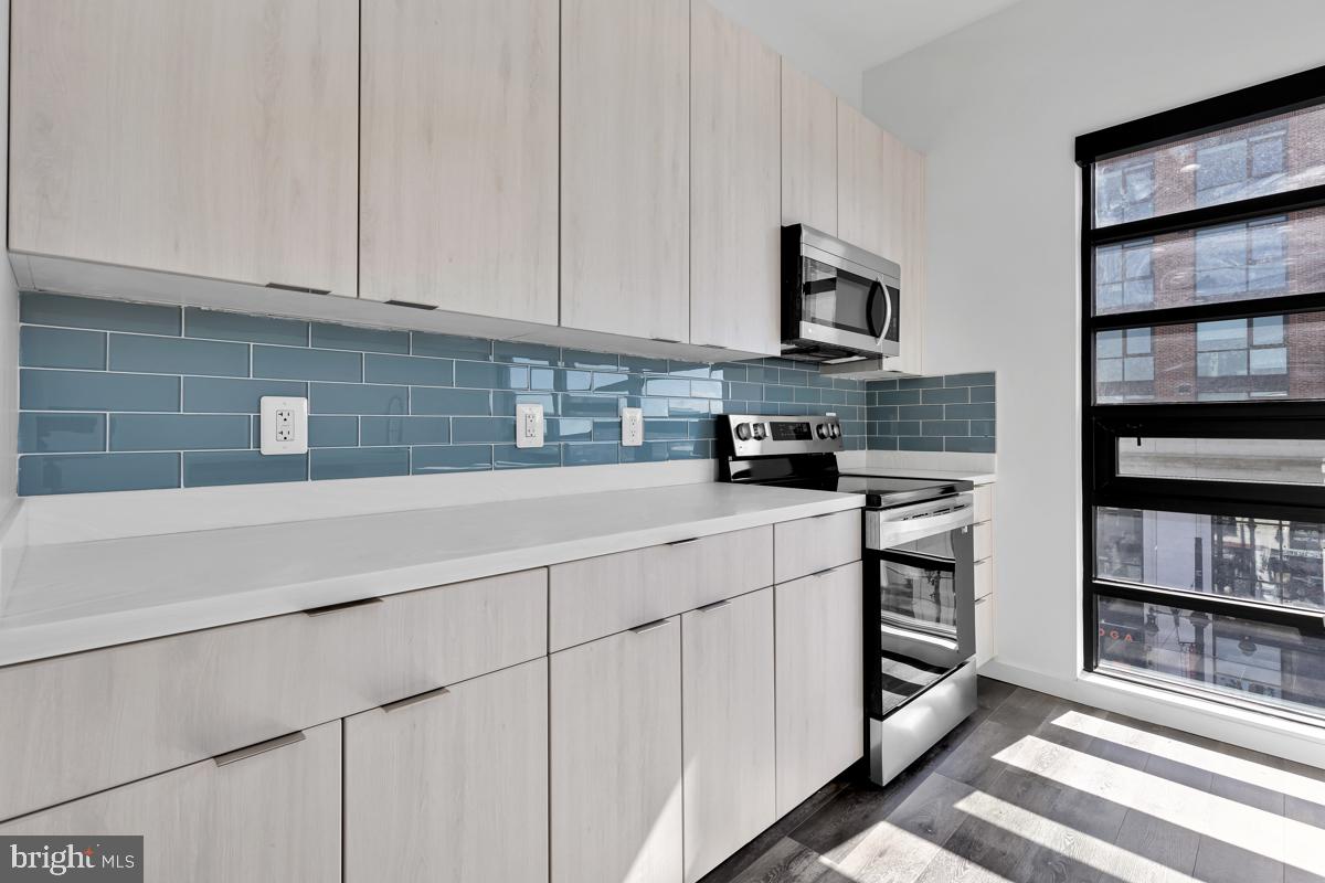 506 H Street Northeast, Unit 401 Washington, DC 20002 - Photo 6 of 19 a kitchen with stainless steel appliances granite countertop a sink and a stove