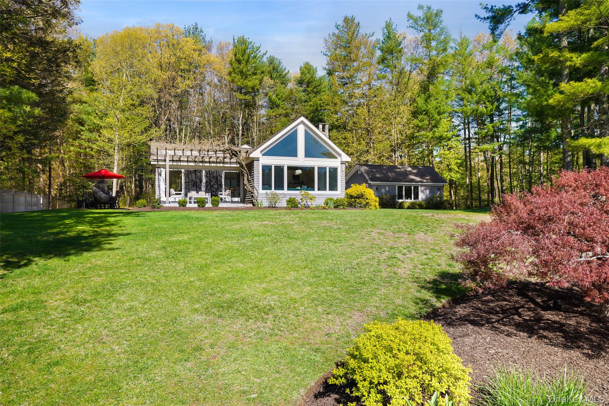 559 Pound Ridge Road Pound Ridge, NY 10576 - Photo 19 of 21 a front view of a house with garden