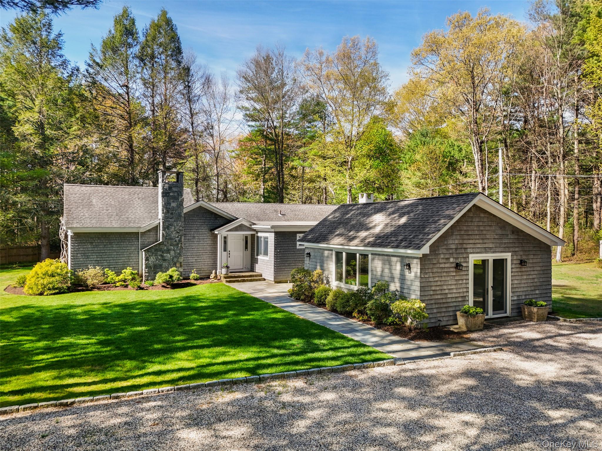 559 Pound Ridge Road Pound Ridge, NY 10576 - Photo 3 of 21 a front view of a house with a garden and trees