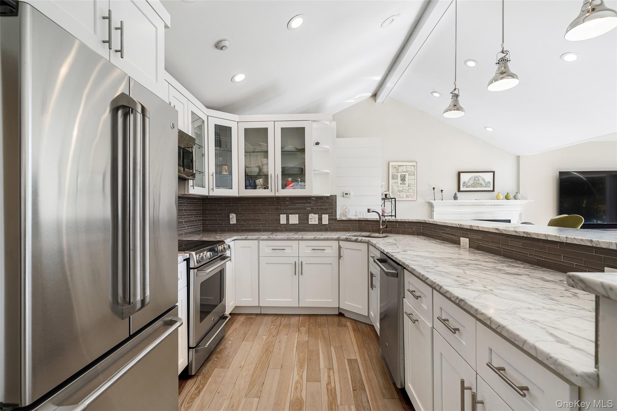559 Pound Ridge Road Pound Ridge, NY 10576 - Photo 8 of 21 a kitchen with stainless steel appliances granite countertop a refrigerator a sink dishwasher a stove and white cabinets with wooden floor