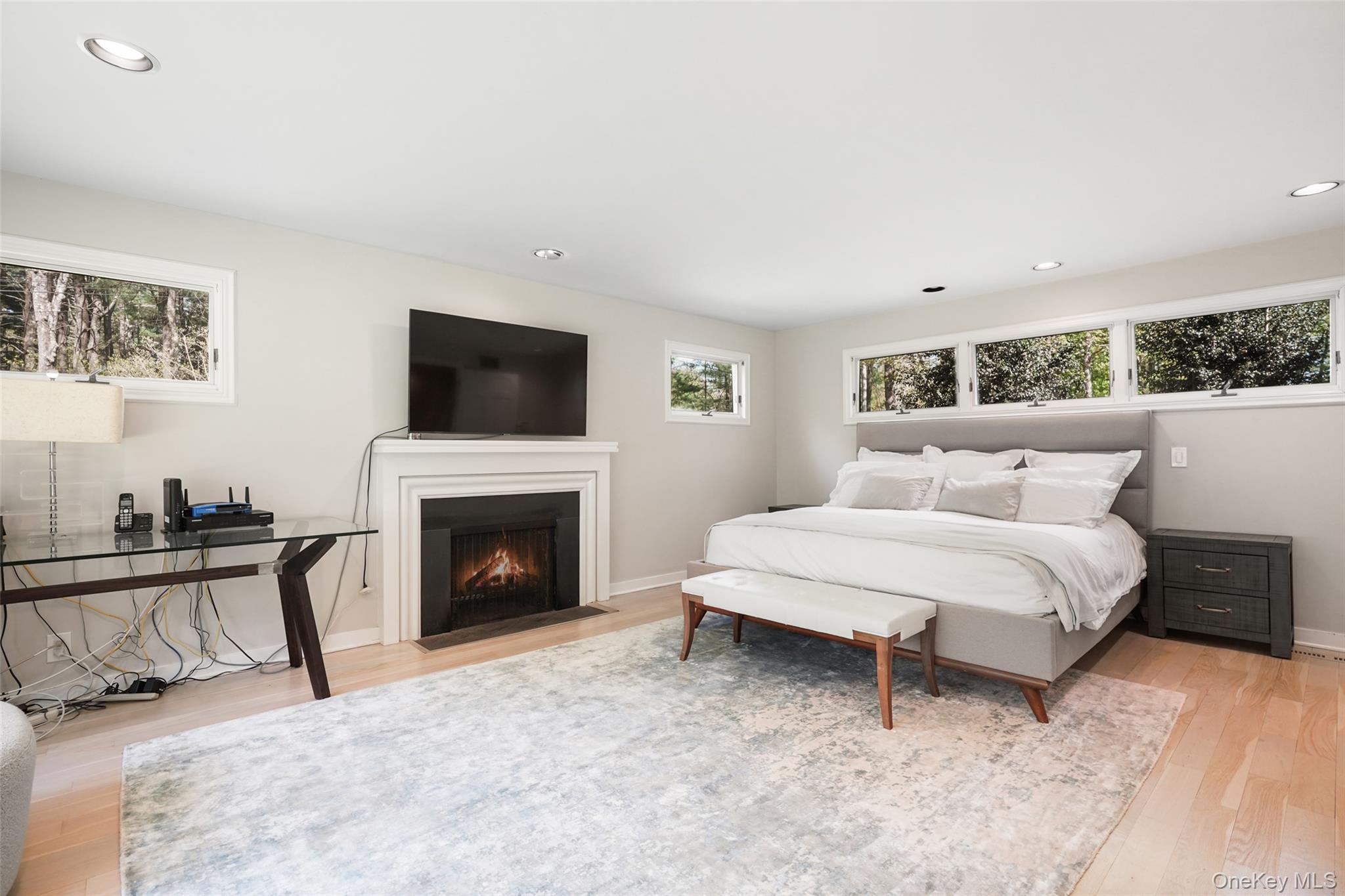 559 Pound Ridge Road Pound Ridge, NY 10576 - Photo 10 of 21 a spacious bedroom with a bed and a fireplace