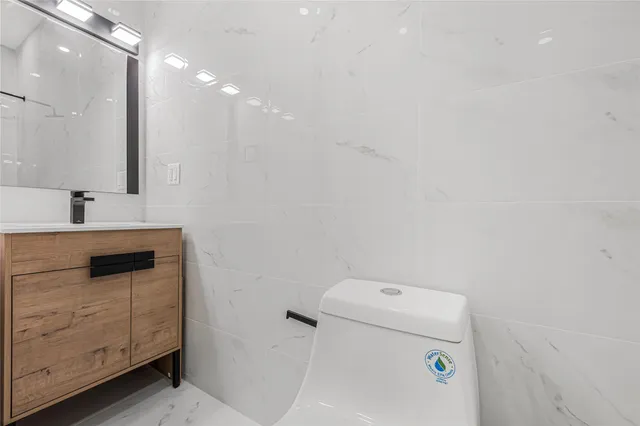 a bathroom with a sink a toilet and mirror