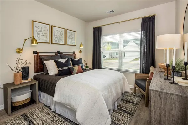 a bed room with a bed and a chair