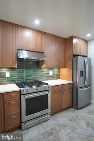 a kitchen with a stove and a refrigerator