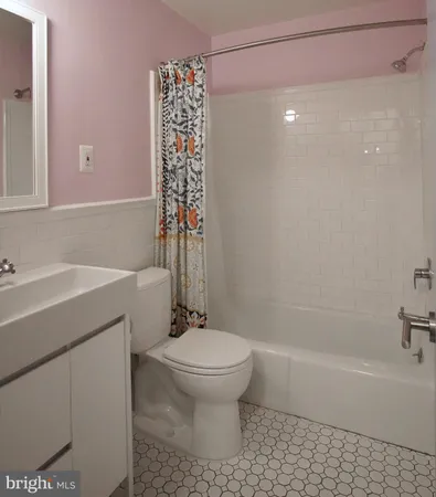 a bathroom with a shower a toilet and sink