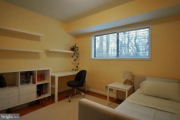 a view of a livingroom with workspace and a window