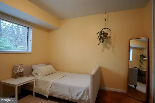 a bedroom with a bed and a mirror