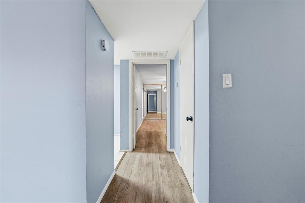5604 Boca Raton Boulevard, Unit 248 Fort Worth, TX 76112 - Photo 17 of 25 a view of a hallway with wooden floor