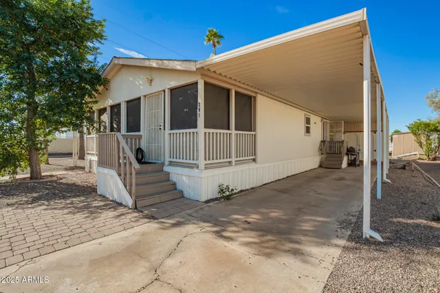 a view of a white house with a yard