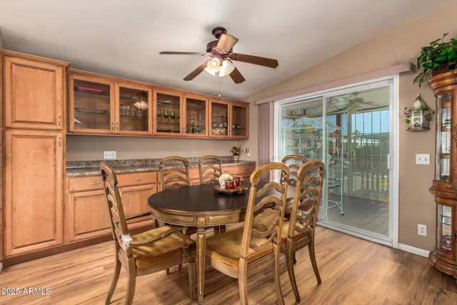 a dining room with furniture a chandelier and wooden floor