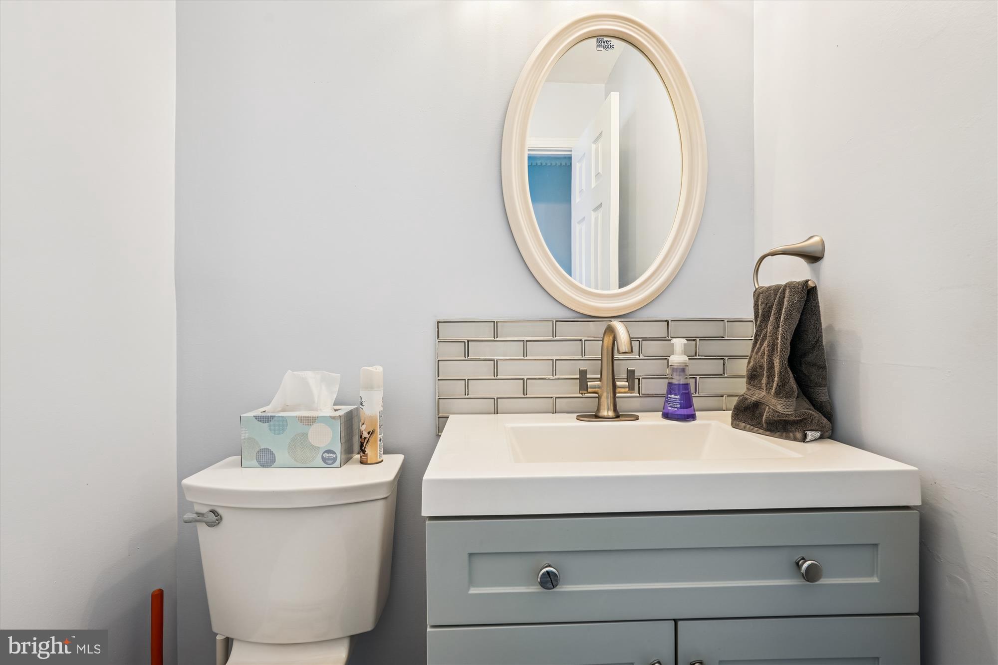 15418 Peach Orchard Road Silver Spring, MD 20905 - Photo 15 of 47 Chic powder room with modern finishes.