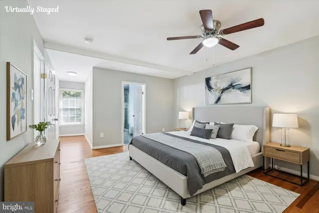a spacious bedroom with a bed and ceiling fan